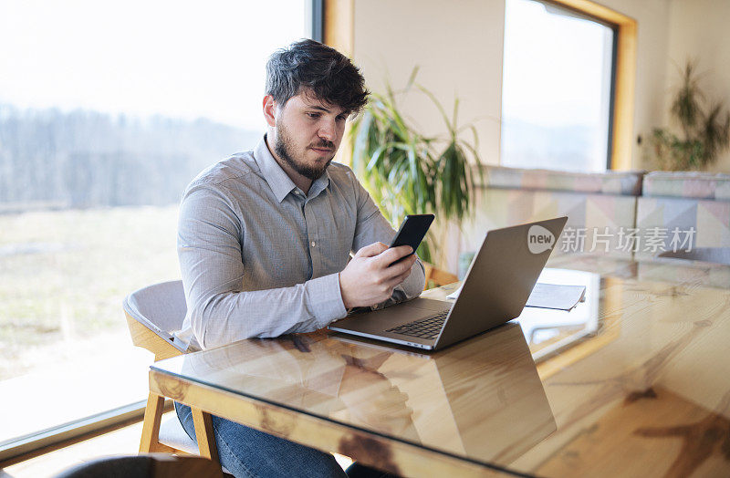 Multi tasking businessman at home.